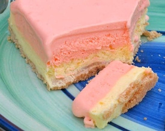 A close up photo of a slice of frozen lemonade pie. 