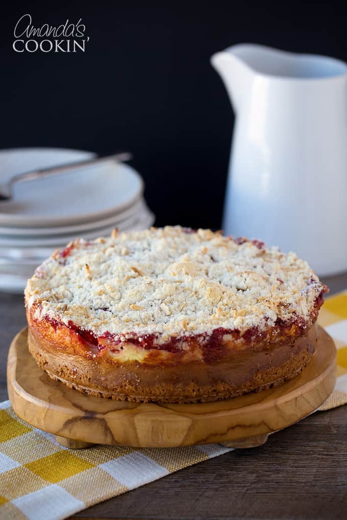 cherry cream cheese coffee cake on a round wood board