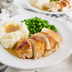 sliced chicken with mashed potatoes and gravy on a plate