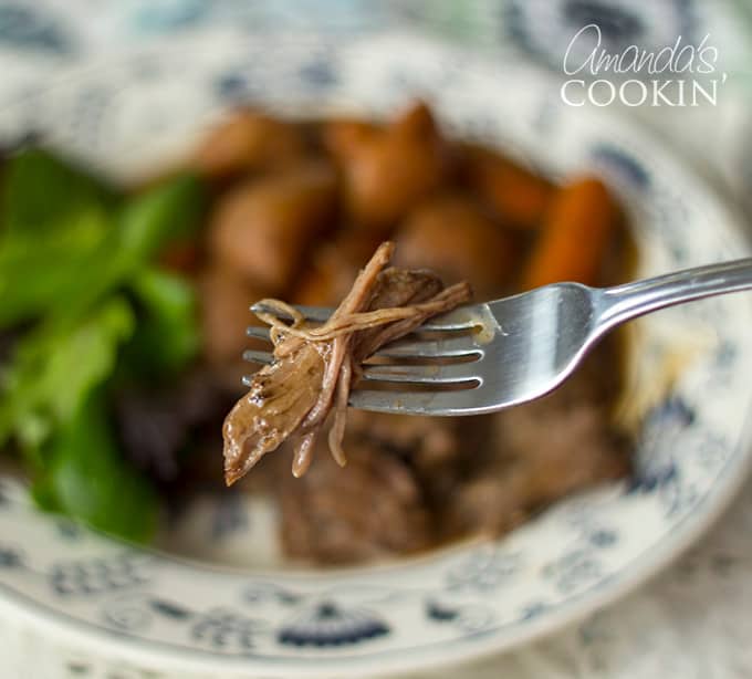 fork holding crockpot roast beef