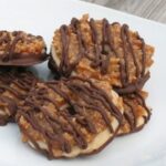A close up photo of girl scout copycat somoas cookies on a white plate.