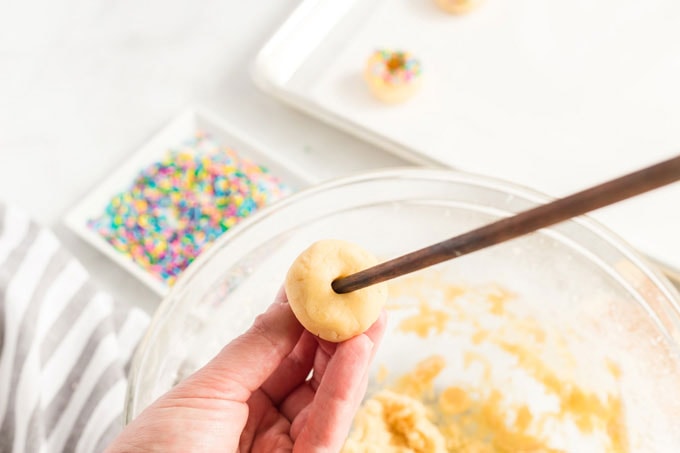 inserting a skewer into a sugar cookie ball