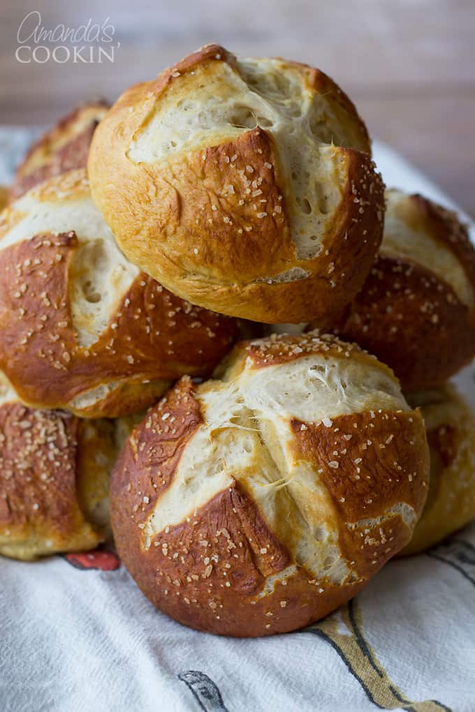 A close up of bretzel rolls resting in a bowl.