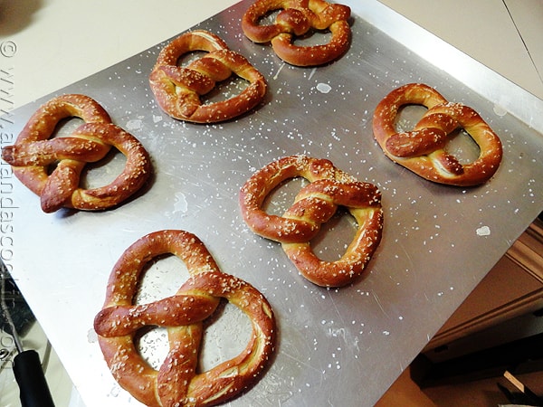 An overhead of homemade German pretzels on a baking sheet.