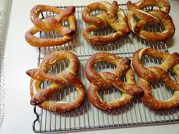 An overhead of homemade German pretzels on a cooling rack.