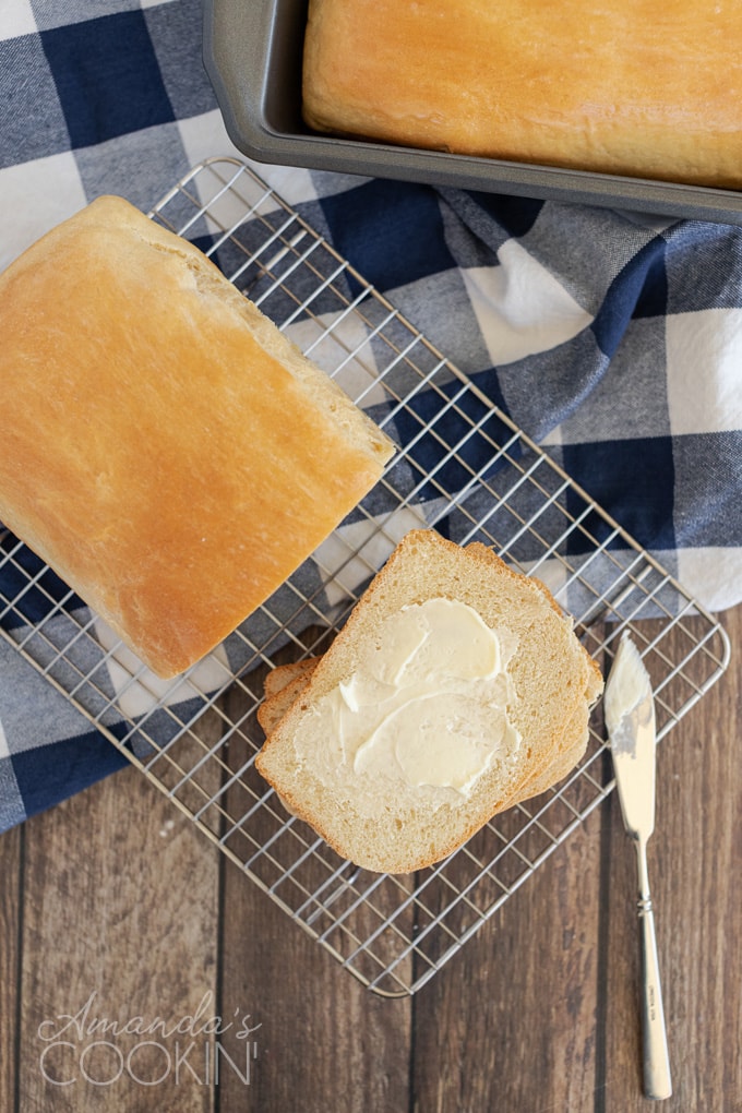 overhead view of amish white bread with a buttered slice