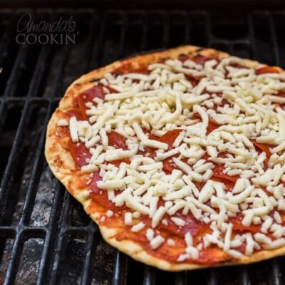 A close up of a pizza on a grill