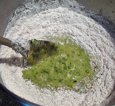 An overhead photo of the dry ingredients being mixed into the zucchini mixture.