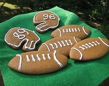 A photo of soft gingerbread football cookies resting on a napkin.