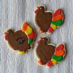 A photo of three thanksgiving turkey cookies.