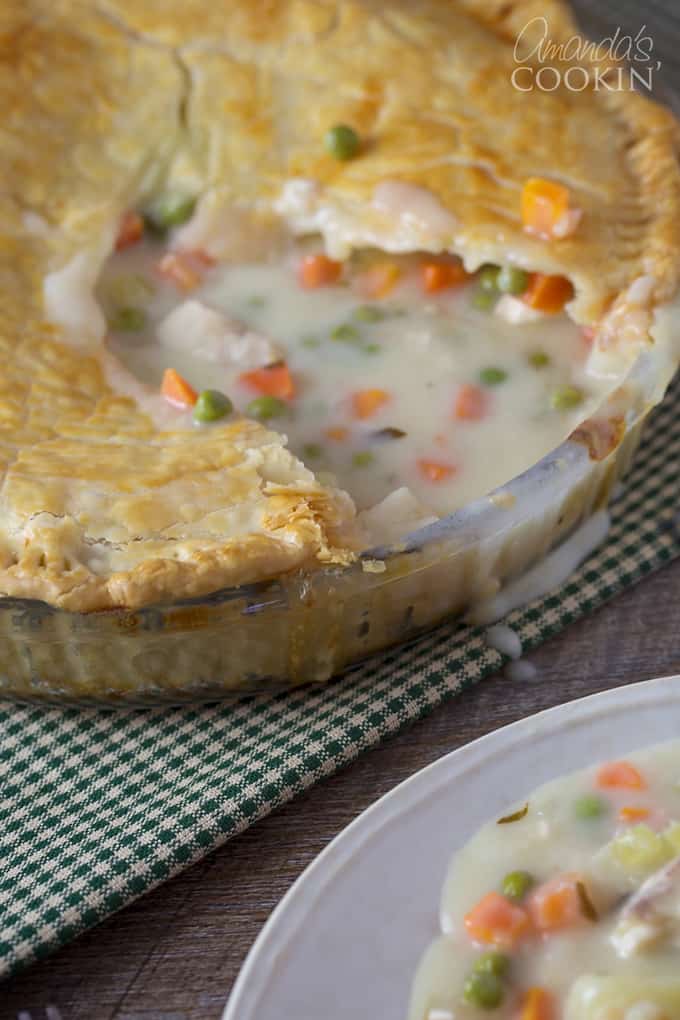 A close up of a homemade pot pie with a slice removed.