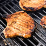close up of pork chop on grill