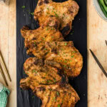Grilled Breaded Pork Chops on black platter