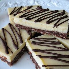 A close up photo of almond cheesecake bars.