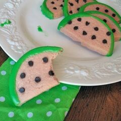 A close up photo of watermelon cookies on a white plate.