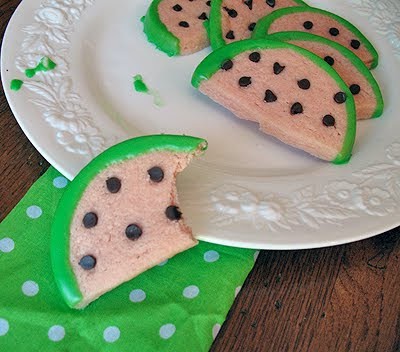 A close up photo of watermelon cookies on a white plate.