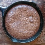 An overhead photo of a cast iron skillet filled with freshly baked brownies.