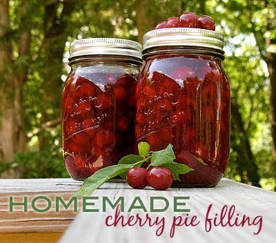A photo of two jars of homemade cherry pie filling.