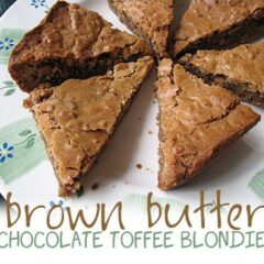 A photo of brown butter chocolate toffee blondies on a plate.