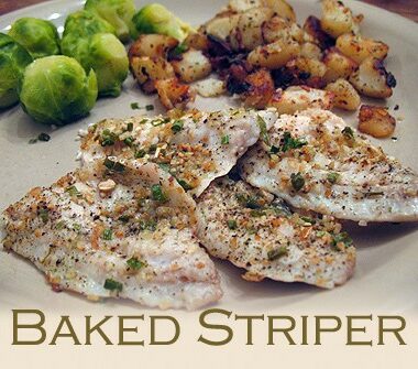A close up photo of baked striper on a plate with brussels sprouts in the background.