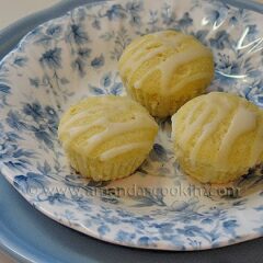 A close up photo of three German mini lemon cakes in a blue and white dish.