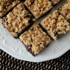 A close up photo of chewy cookie crunch bars on a white plate.