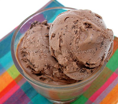 A close up photo of double chocolate chip ice cream in a clear dish.