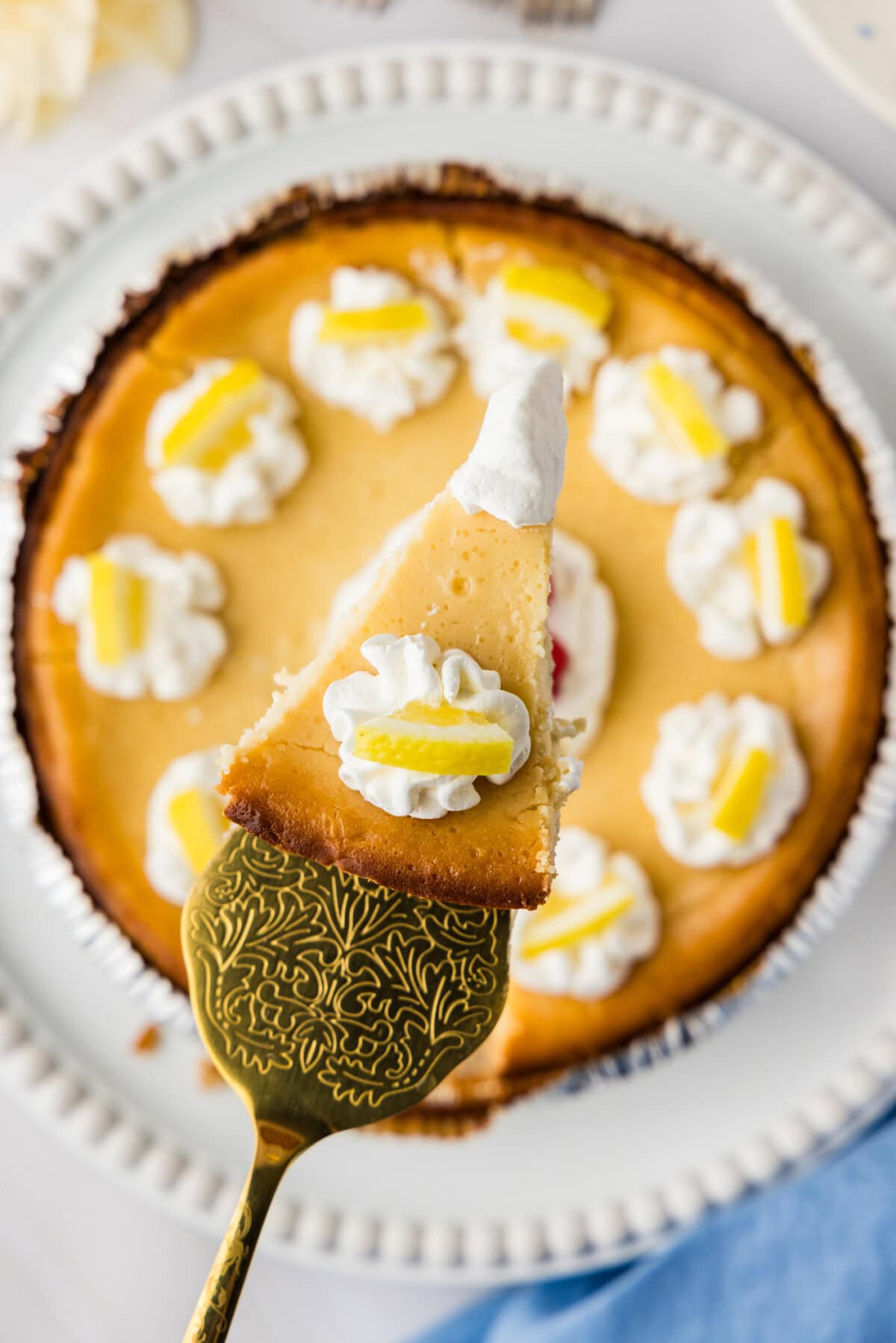 slice of Lemonade Cheesecake being removed from pan
