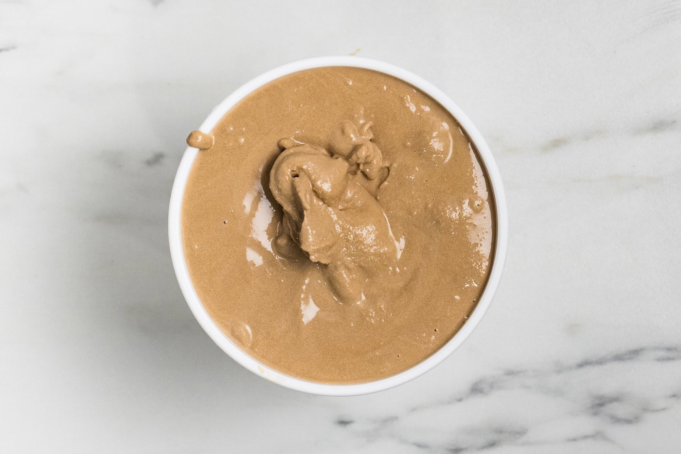homemade Root Beer Ice Cream in tub ready for freezer