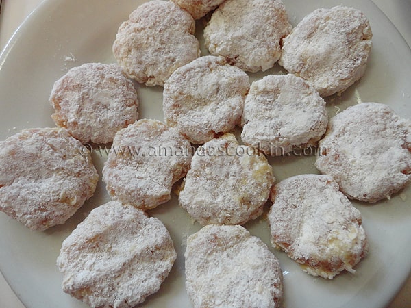 A close up photo of raw chicken nuggets ready for frying.