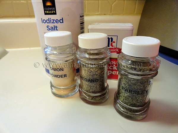 A photo of onion powder, oregano and parsley in glass jars.
