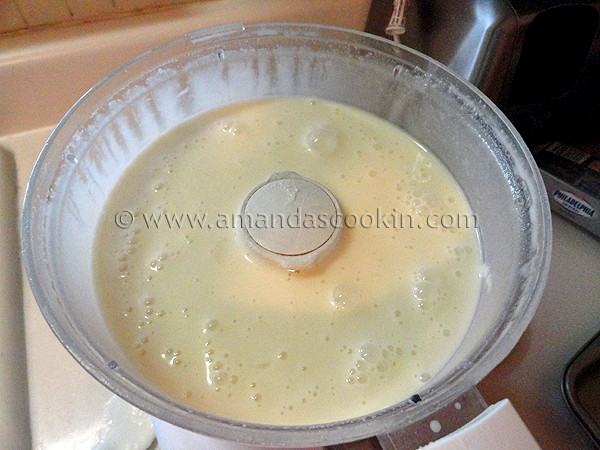 A photo of the ingredients for lemonade cheesecake in a food processor. 