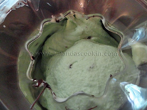A close up of a ice cream maker churning ice cream