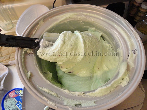 rubber spatula lifting churned ice cream from ice cream maker