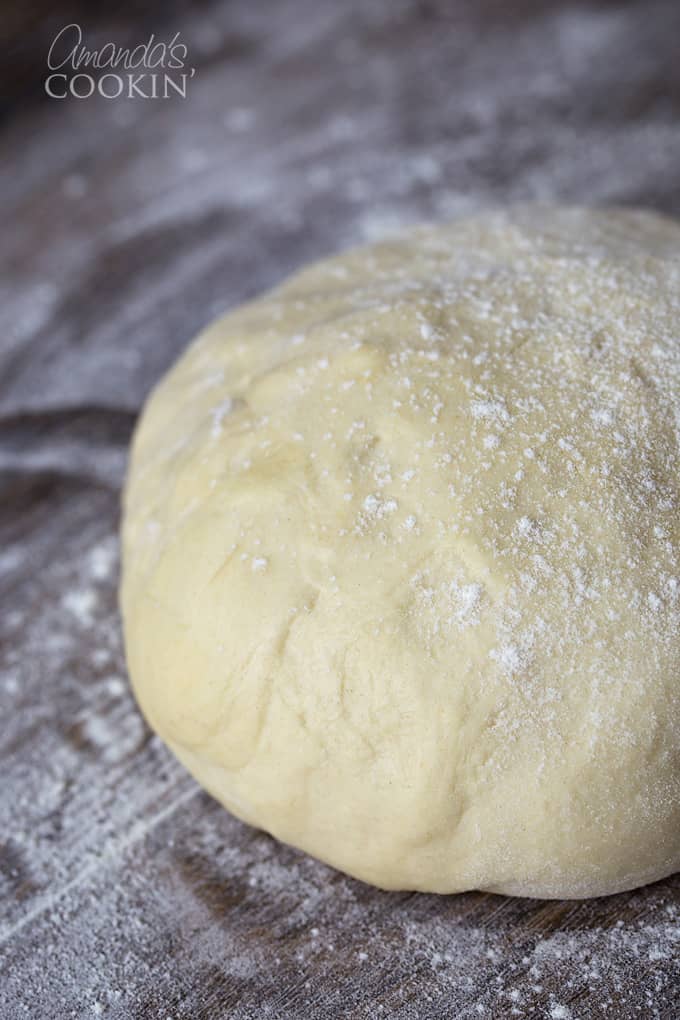 A close up of Parmesan garlic dough with flour dusted on top.