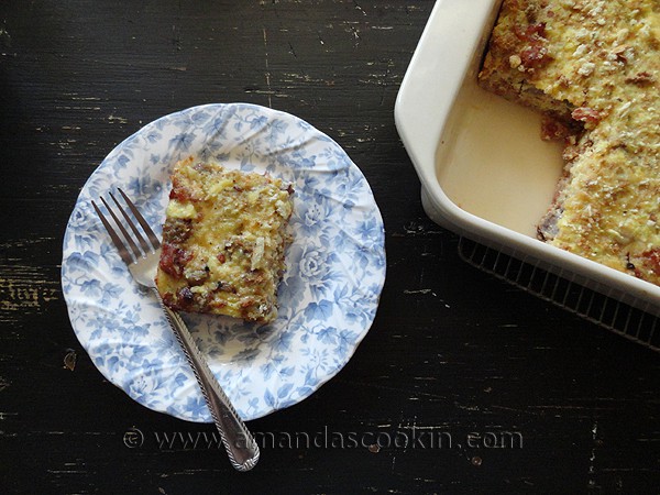 An overhead photo of a serving of herbed breakfast stuffing casserole on a white and blue plate.