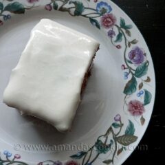An overhead photo of a square of low fat carrot cake on a decorative plate.