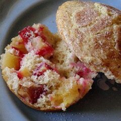 A close up photo of a sugar crusted plum muffin cut in half.
