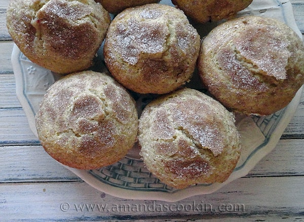 An overhead photo of sugar crusted plum muffins on a plate.