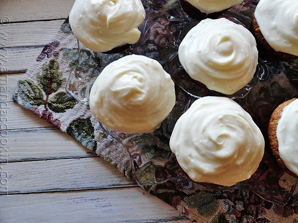 An overhead photo of banana cupcakes with vanilla cream cheese frosting.