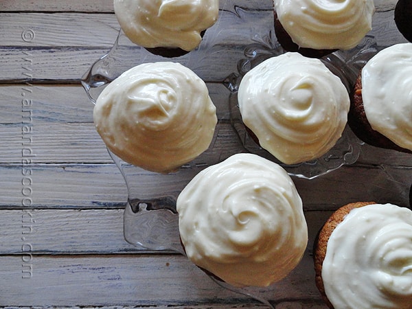 An overhead photo of banana cupcakes with vanilla cream cheese frosting.