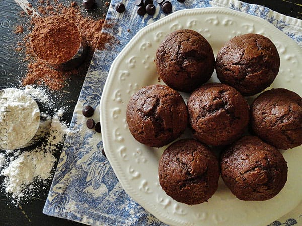 An overhead photo of copycat Starbuck\'s hot cocoa chocolate chip muffins on a white plate.