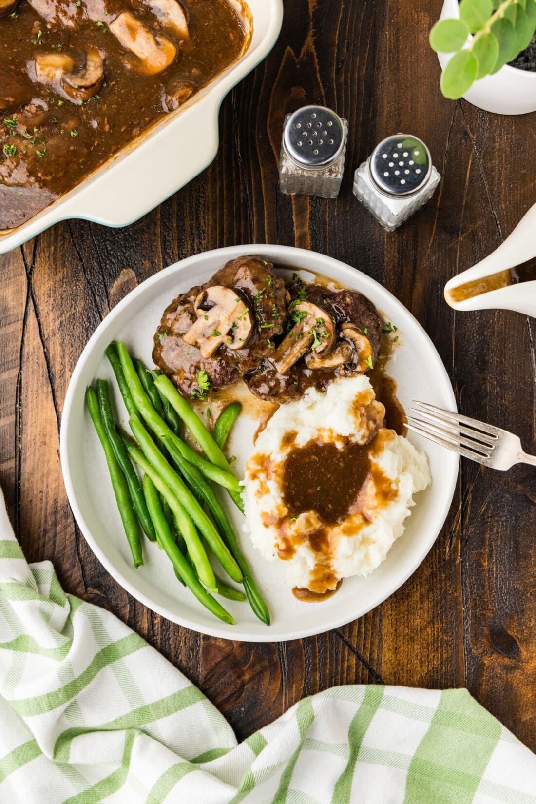 A plate of Salisbury steak on a table