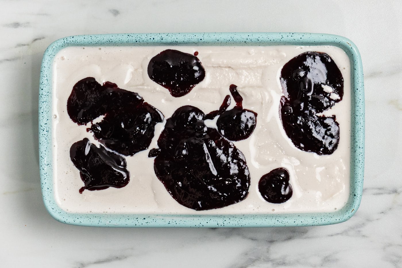 blackberry jam dolloped on top of churned ice cream