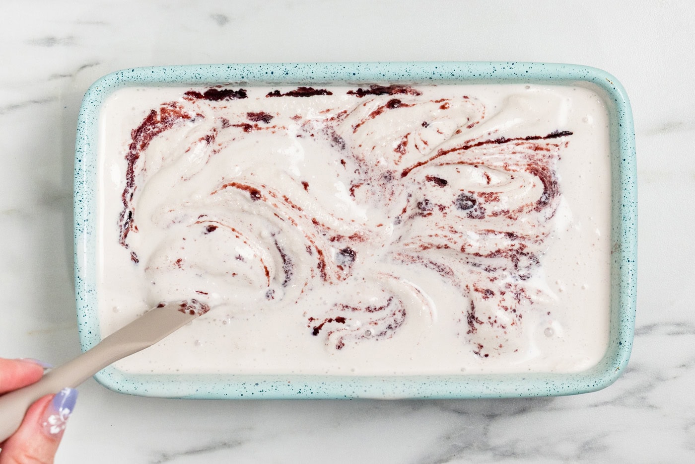 swirling jam into ice cream