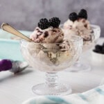 two dishes of jam ice cream garnished with blackberries