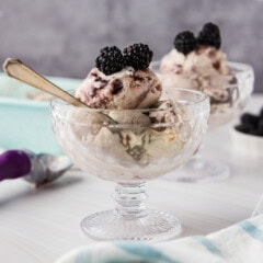 two dishes of jam ice cream garnished with blackberries