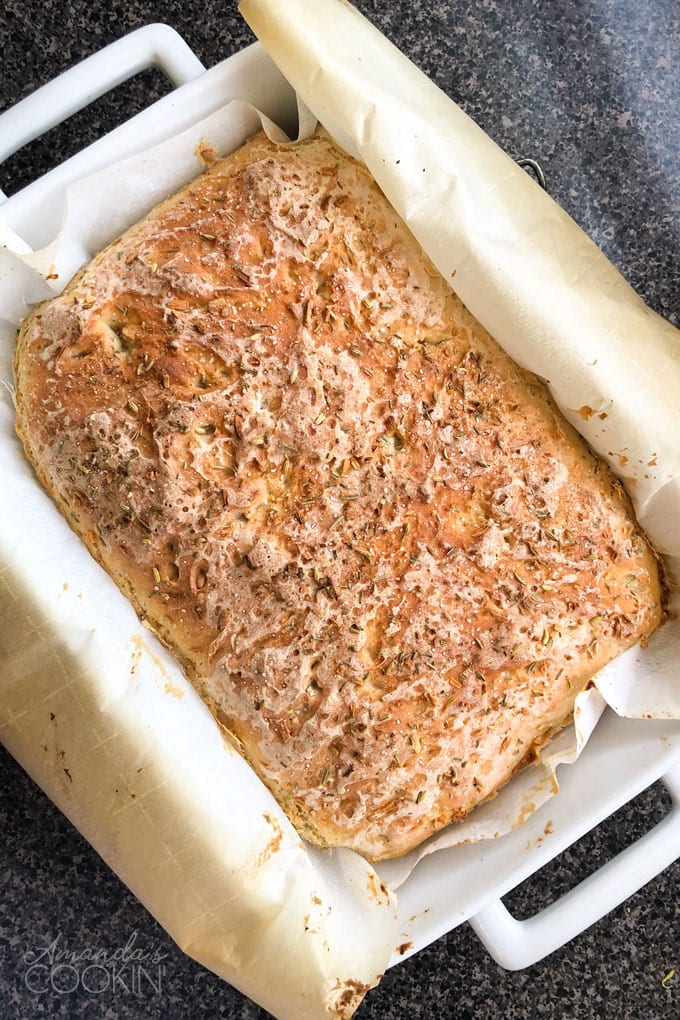 pachment paper lined baking pan with peasant bread from the oven