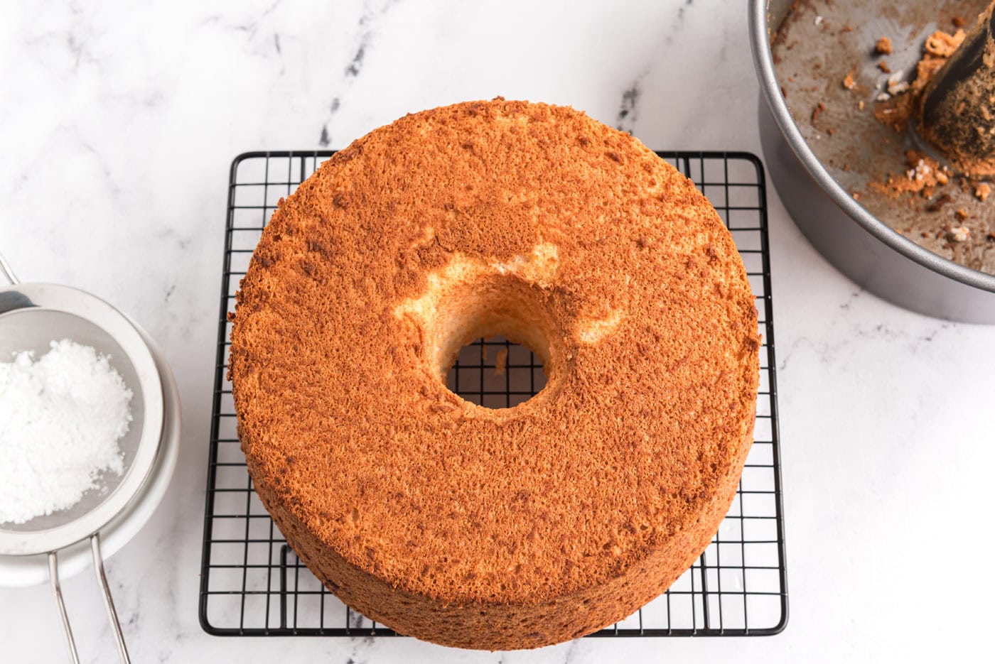 baked angel food cake on a wire cooling rack