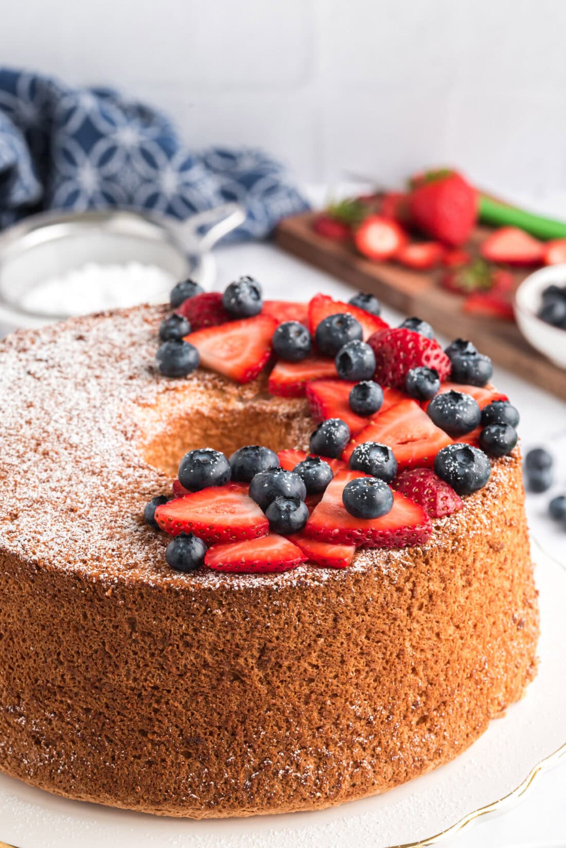 Angel Food Cake topped with powdered sugar and berries